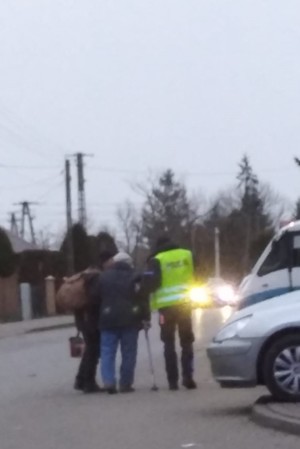 policjant pomaga iść osobie niepełnosprawnej